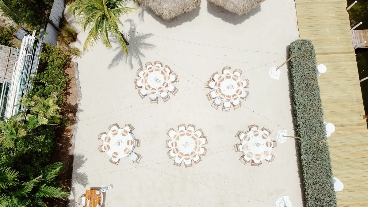 Seaside Setups website showing a Florida Keys beach wedding setup with white draped arch and chairs on the sand